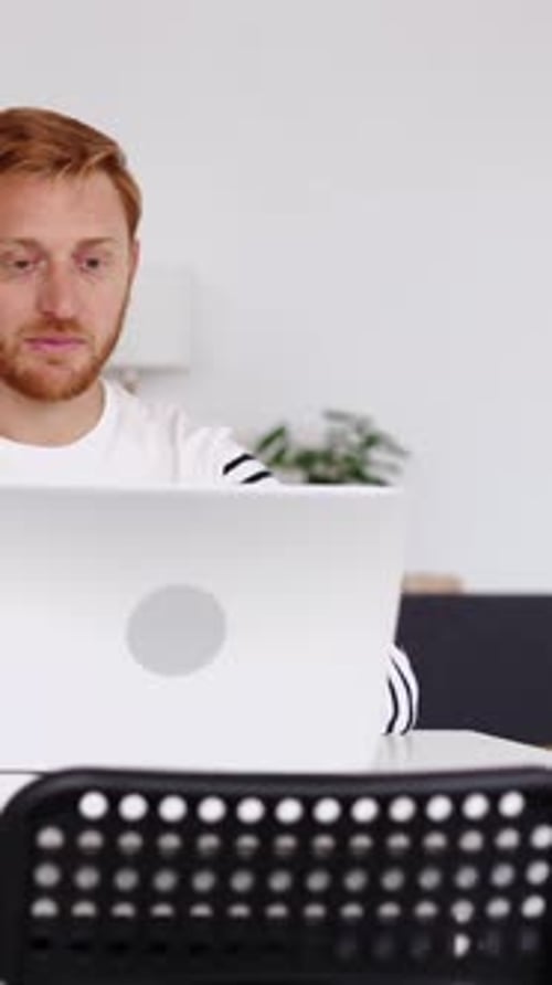 Young Adult Talking to Computer in Modern Interior