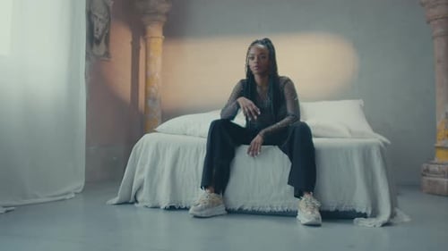 Woman with Braids Posing Fashionably in Bedroom