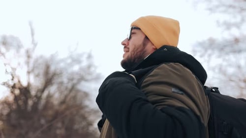 Man with Backpack Enjoying Winter Day in Nature