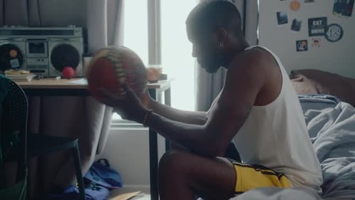 Young Adult Bouncing Basketball in Bedroom