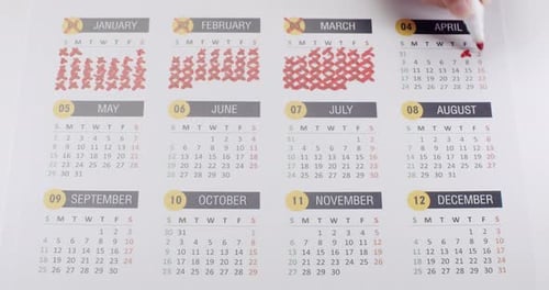 Person Hand Crossed Out Every Day at Year in Paper Calendar