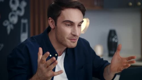 Enthusiastic Young Man Video Conferencing at Home