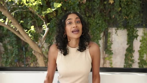 Attractive Young Woman Speaking Outdoors in Daylight