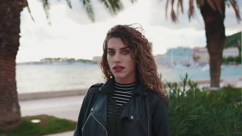 Outdoor Portrait of Nice Fashionable Woman Traveling Alone Staying in Beautiful Tropical City