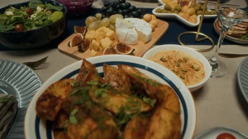 Festive Dining Table with Cheese, Fruit, and Salads