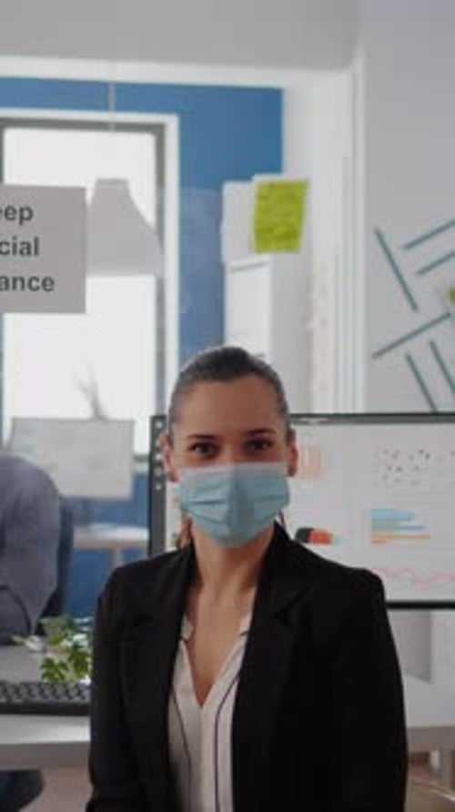 Vertical Video Portrait of Woman Manager Wearing Face Mask to Prevent Infection with Coronavirus