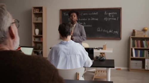 Adult Education Class with Teacher and Students Learning