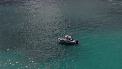 Aerial Zoom Shot of a Boat Sailing to the Blue Sea