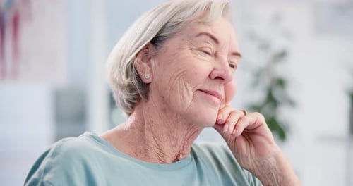 Memory, reflection and senior woman in a clinic for a healthcare or wellness consultation