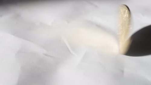 Hand Spinning Solid Gold BitCoin Until It Stops On White Background. Slow Motion