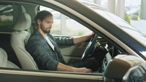 Man Smiling Inside New Car at Dealership