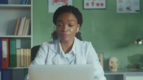 Doctor Analyzing Patient Records Clinician Concentrating on Virtual Diagnosis with Models and Charts