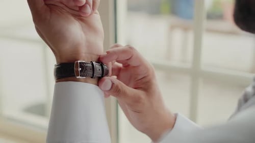 Man Fastens Leather Watch Buckle on Wrist