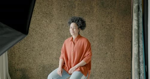 Portrait of an African American Woman sitting in a Photographic studio