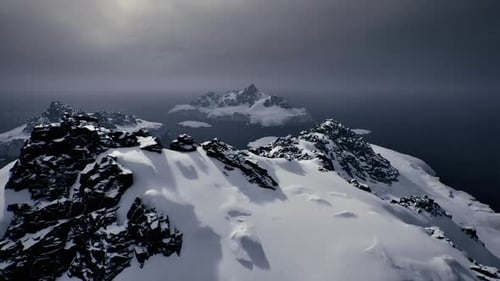 Snowy Mountain Heights and Distant Icy Islands Overlook Wild Sea
