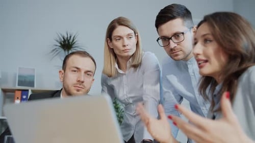 Business Team Meeting to Discuss Project on Laptop