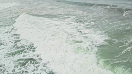 Professional surfer surfing on big ocean waves at Manhattan Beach in California, USA.