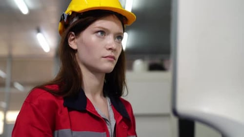 Woman Engineer Working with Electronic Device in Factory