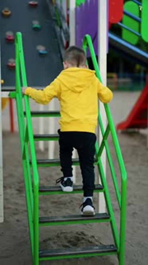 Child Climbing Playground Steps Outdoors