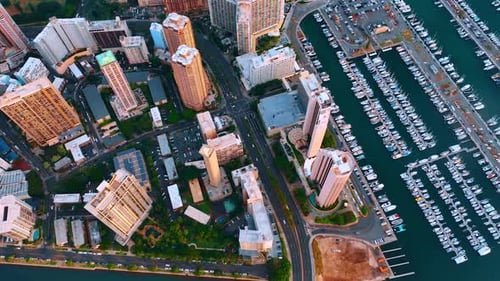 Flying above the cityscape, luxurious yacht club and sandy beach. Panorama of Waikiki, Honolulu