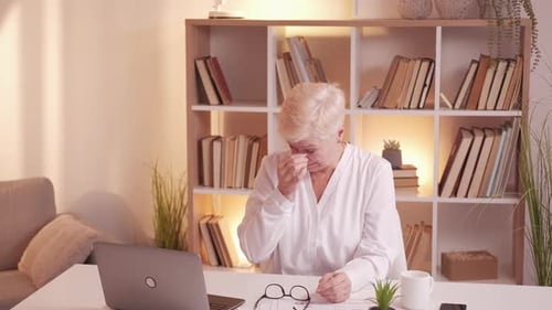 Mature Woman with Short Blonde Hair at Home
