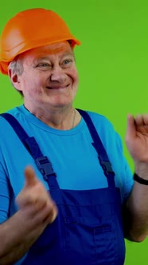 Senior Worker in Overalls Applauding and Expressing Admiration