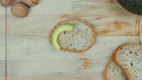Preparing Avocado Toast on Wooden Cutting Board