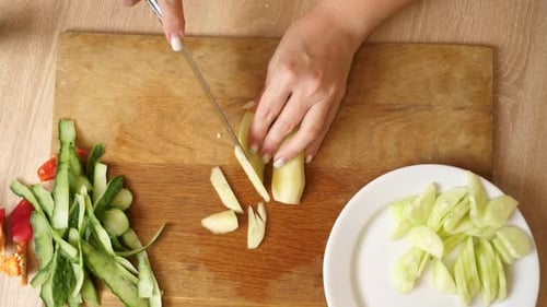 08Cucumber is cut into pieces with a knife. Cooking dishes from vegetables.