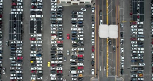 Top view of parked cars in parking spots, near the shopping center.
