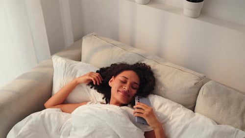 Woman Resting in Bed, Using Mobile Phone
