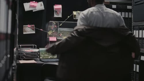 Man Arrives at Overloaded Office, Sits at Desk