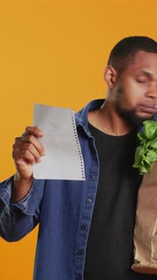 Vertical Video Vegan Person Checking His Grocery Shopping List to Buy Everything He Needs