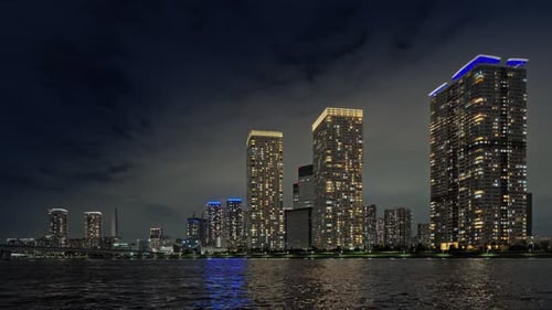 Dramatic Night Sky Over Sparkling Modern City Skyline Water Reflections