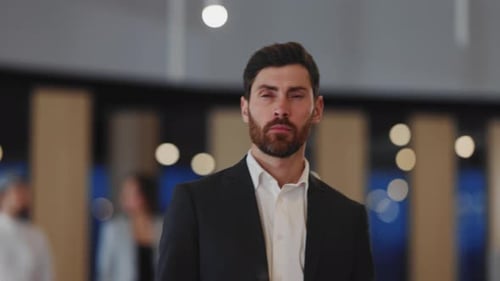 Man in Suit Walks Through Office With Colleagues