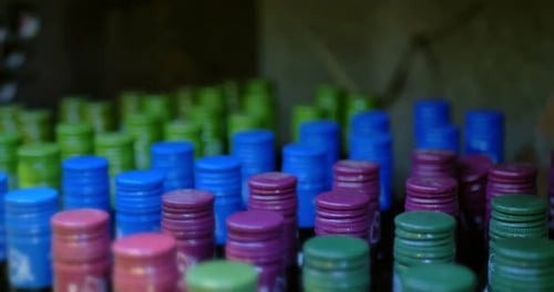 Multicolored Metal Caps on Bottles with Dust
