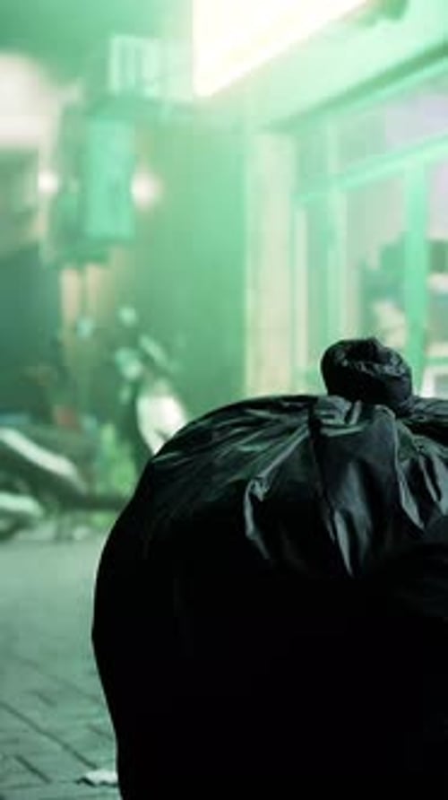 A Trash Bag Sitting on the Side of a Street