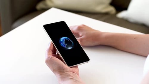 Woman Holding Smartphone with Technology Interface Indoors