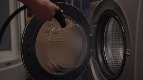 Close Up Cleaning Washing Machine with Steamer