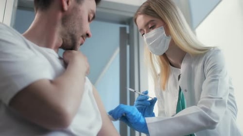 Hospital Employee Injects Vaccine of COVID-19 in Hand at Medical Room. Vaccination