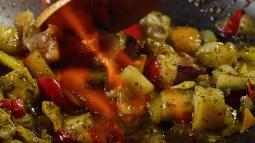 Chef Cooking Flambe Vegetables on Frying Pan Closeup Color Vegetables with Some Spice Restaurant