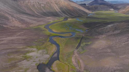 Aerial View of Iceland's Green Valley with Winding River and Hills