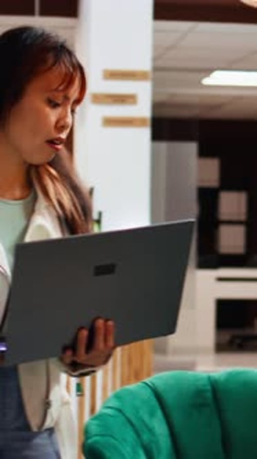 Vertical Video Hotel Guest Finishing Work Tasks on Laptop Upon Her Arrival