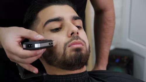 Man Getting Beard Trimmed at Barbershop