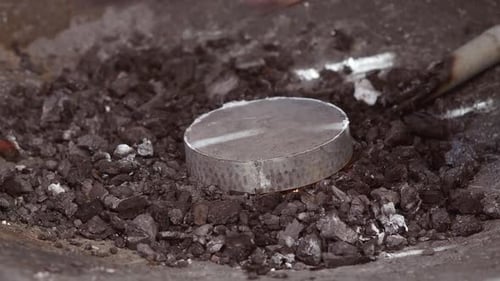 Metal Piece Heating in Glowing Coal Forge Fire