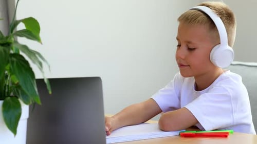 Child Studying with Laptop and Headphones at Home