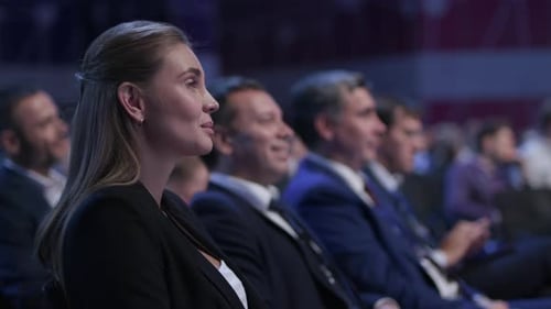 Audience watching business presentation at corporate conference