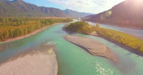 Low Altitude Flight Over Fresh Fast Mountain River with Rocks at Sunny Summer Morning