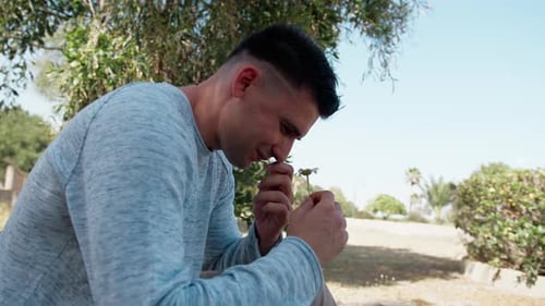 Young Adult Smells Flower Then Begins Coughing