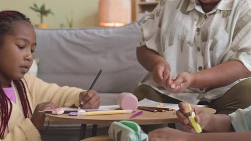 Children Drawing Together with Adult Supervision at Home