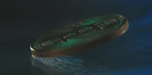 Gold Bitcoin Cryptocurrency Coin Spinning on Dark Surface